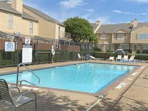 community pool featuring a residential view and fence