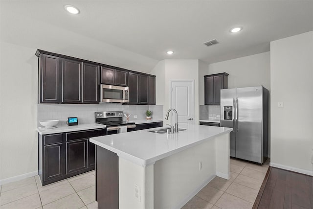 kitchen featuring light tile patterned floors, visible vents, stainless steel appliances, and a sink