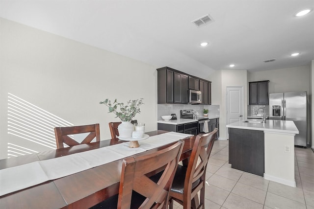 kitchen featuring light tile patterned floors, tasteful backsplash, visible vents, appliances with stainless steel finishes, and light countertops