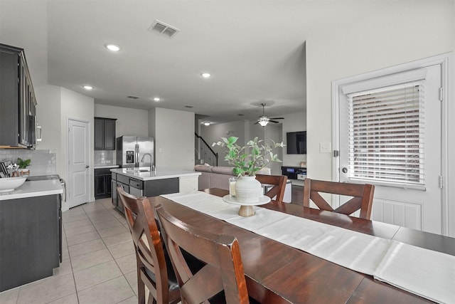 dining area featuring light tile patterned floors, recessed lighting, visible vents, ceiling fan, and stairs