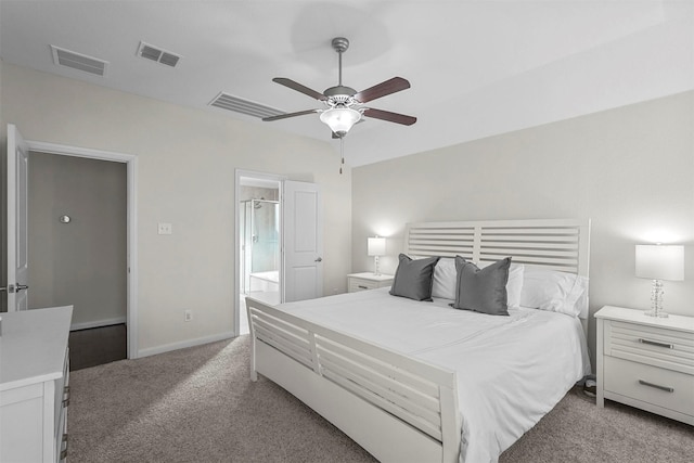 bedroom with light colored carpet, baseboards, visible vents, and ensuite bath