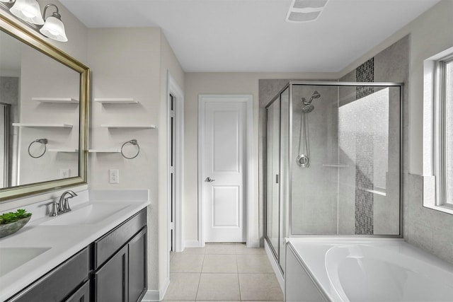 full bathroom featuring a garden tub, a shower stall, a sink, and tile patterned floors