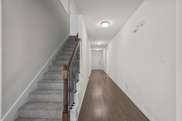 stairway with baseboards and wood finished floors