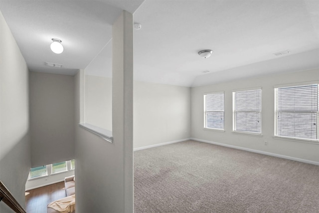 spare room featuring a wealth of natural light, visible vents, and baseboards