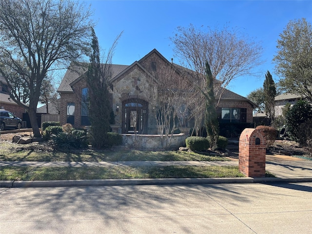 view of front of house with stone siding and brick siding