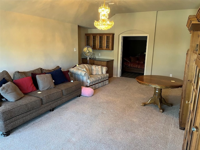 living area with a chandelier and carpet flooring