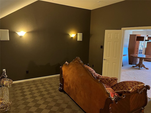 cinema room featuring baseboards and vaulted ceiling