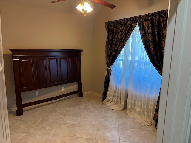 unfurnished bedroom with ceiling fan and baseboards