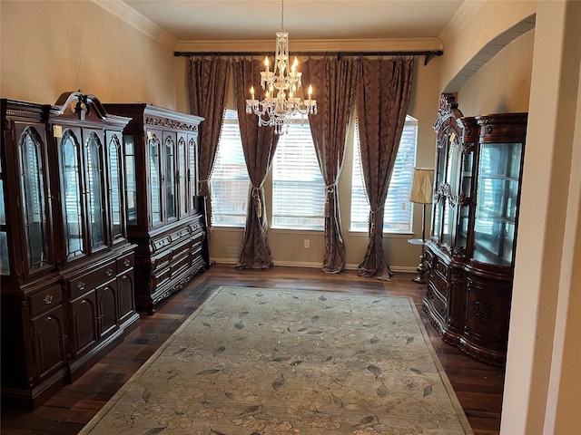 dining space with a chandelier, dark wood-type flooring, baseboards, and crown molding