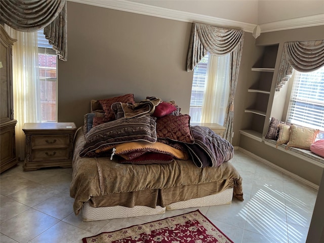 bedroom with ornamental molding, baseboards, and light tile patterned floors