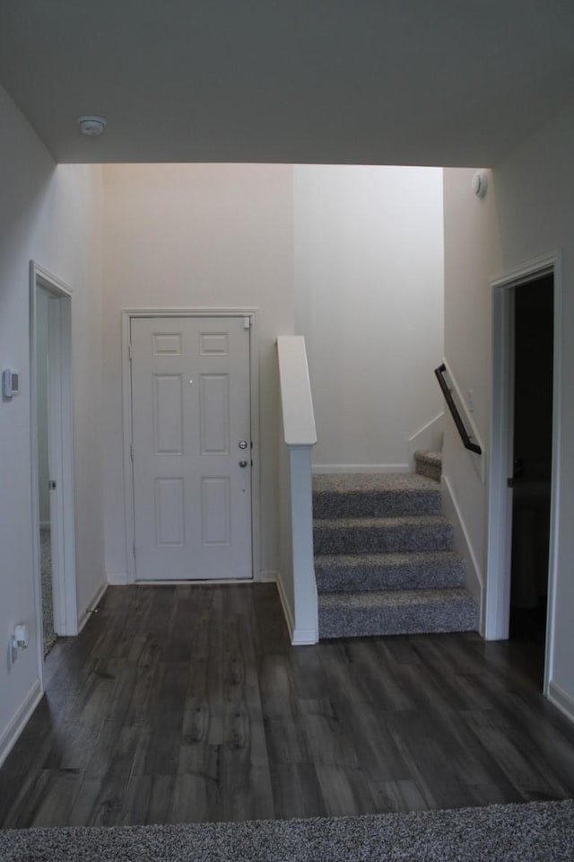 entryway featuring stairs, baseboards, and wood finished floors