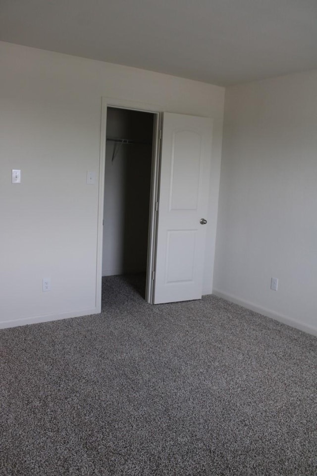 unfurnished bedroom featuring carpet floors and a closet