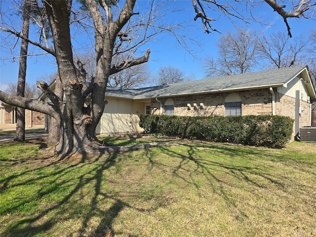 view of property exterior with brick siding, a lawn, and cooling unit