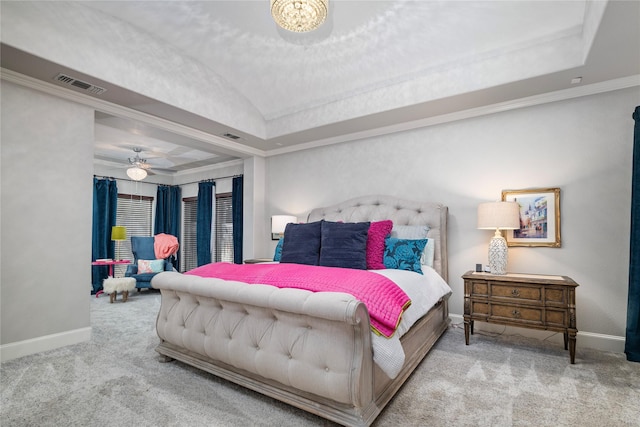 carpeted bedroom featuring visible vents, a raised ceiling, baseboards, and ornamental molding