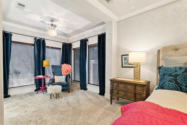 carpeted bedroom with visible vents, baseboards, ornamental molding, and a ceiling fan