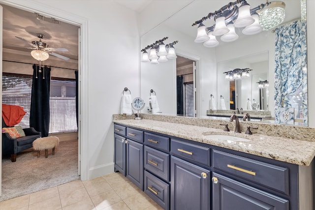 bathroom with tile patterned flooring, vanity, baseboards, and a ceiling fan