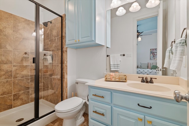 ensuite bathroom with a shower stall, vanity, toilet, and ensuite bathroom