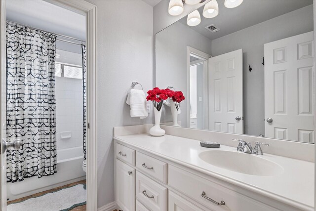 bathroom with vanity, a shower with shower curtain, toilet, and visible vents