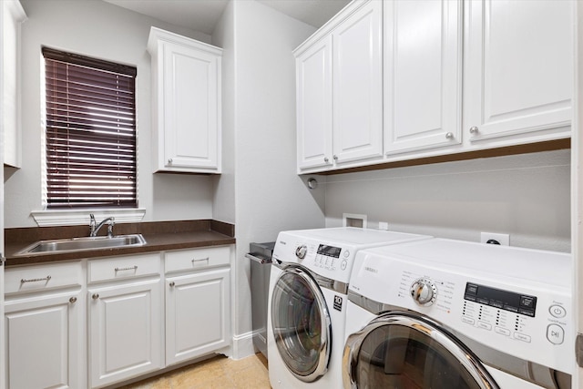 laundry room with washer and dryer, a sink, and cabinet space