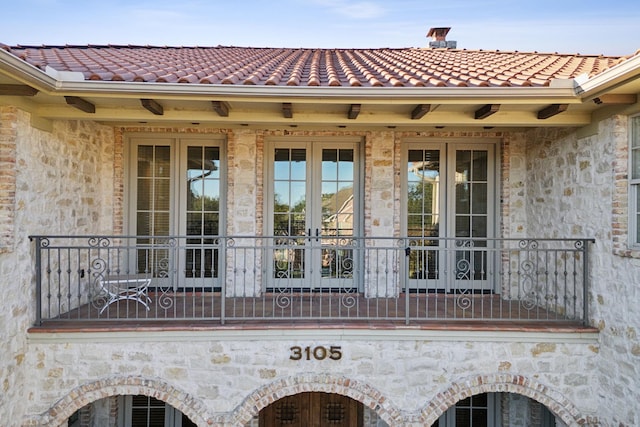 exterior space featuring french doors and a tile roof