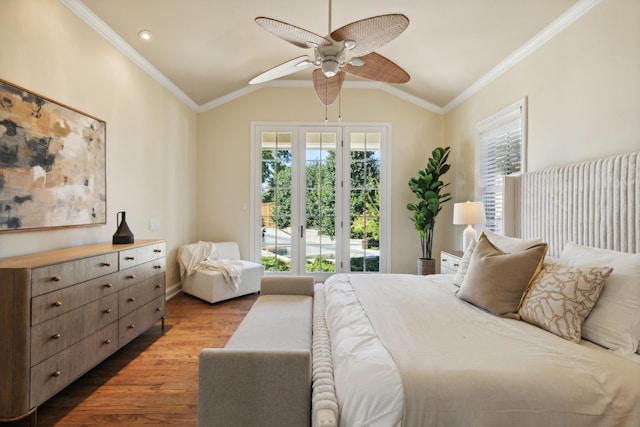 bedroom featuring lofted ceiling, ornamental molding, wood finished floors, and access to exterior