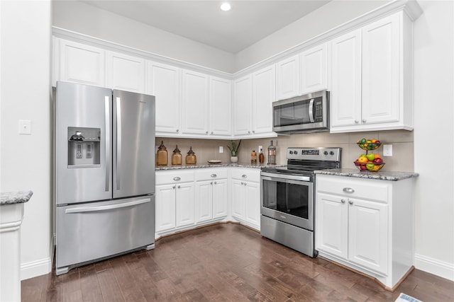 kitchen featuring stainless steel appliances, dark wood finished floors, and backsplash