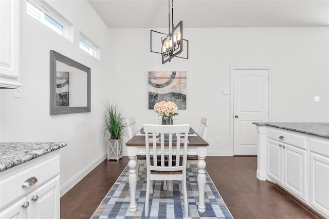 dining room with dark wood-style floors, a chandelier, and baseboards