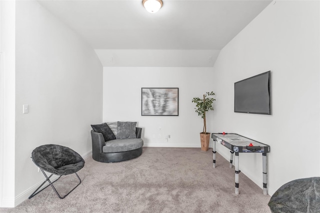 living area featuring carpet, lofted ceiling, and baseboards