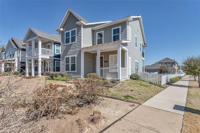 view of front of house with a porch and fence