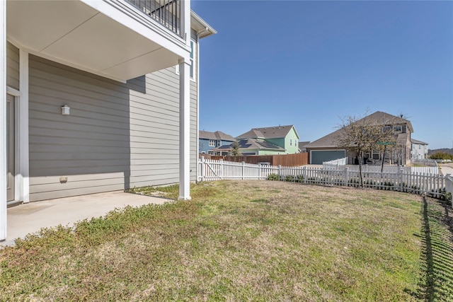 view of yard featuring fence and a residential view