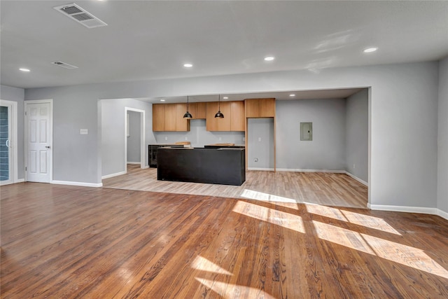 unfurnished living room with baseboards, recessed lighting, visible vents, and light wood-style floors