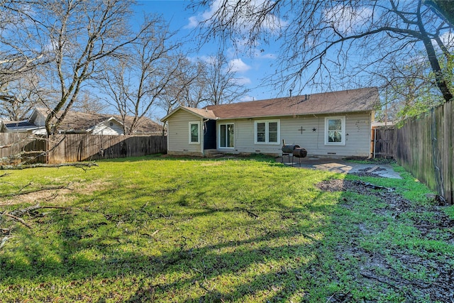 back of house featuring crawl space, a lawn, a patio area, and a fenced backyard