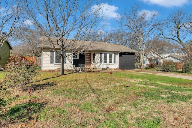 ranch-style house featuring concrete driveway, a front lawn, and an attached carport