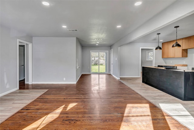 unfurnished living room featuring light wood-style floors, visible vents, and recessed lighting