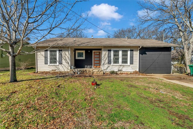 ranch-style home with concrete driveway, covered porch, and a front lawn