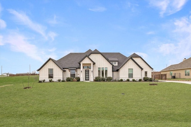 modern inspired farmhouse with a shingled roof, a front lawn, and board and batten siding