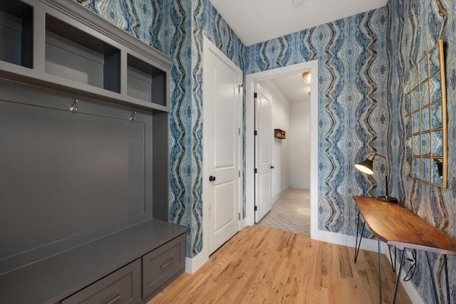 mudroom featuring baseboards, light wood-style flooring, and wallpapered walls