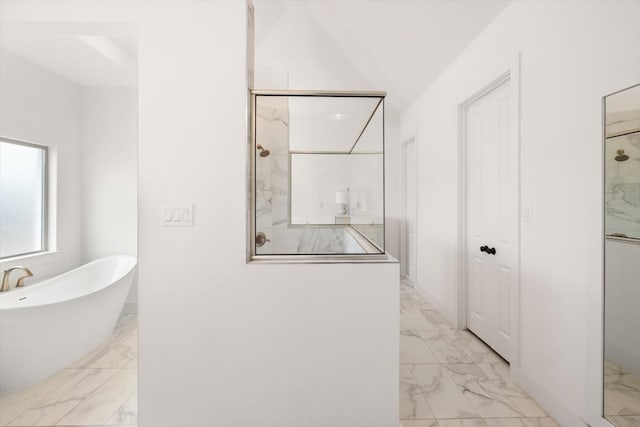 full bath with marble finish floor, a freestanding bath, and a marble finish shower