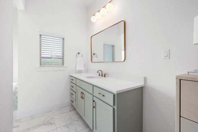 bathroom with marble finish floor, baseboards, and vanity