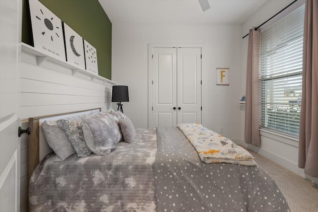 bedroom featuring carpet, a closet, ceiling fan, and baseboards