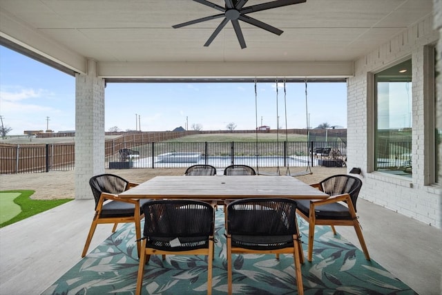 view of patio with outdoor dining area, a fenced backyard, and a ceiling fan