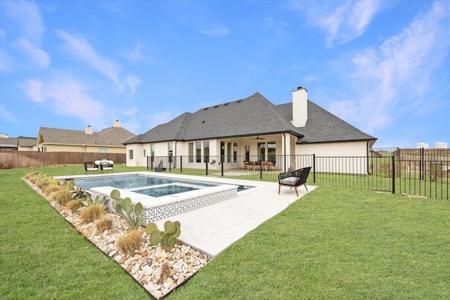 view of pool featuring a yard, a patio, a fenced backyard, and an in ground hot tub