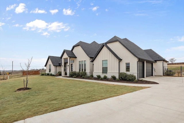 view of front of property with a garage, fence, driveway, a front lawn, and board and batten siding