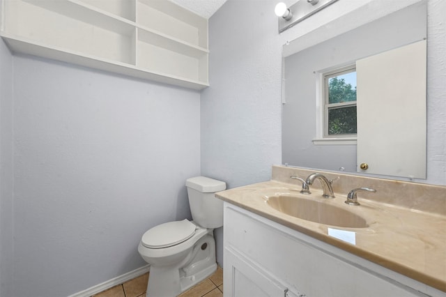 half bath featuring tile patterned flooring, toilet, vanity, and baseboards