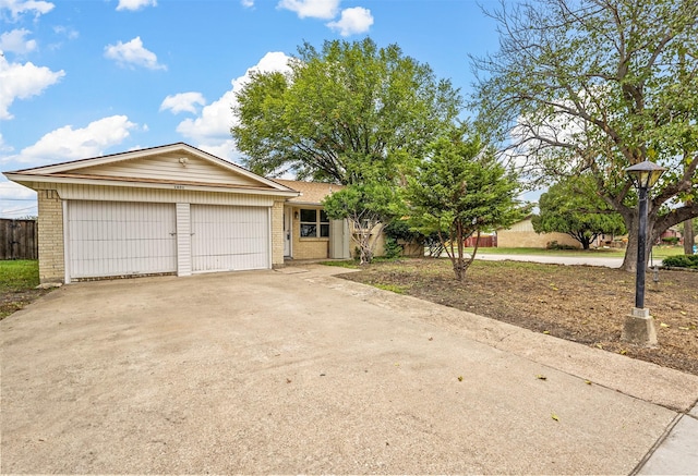 ranch-style home with brick siding, concrete driveway, and a garage