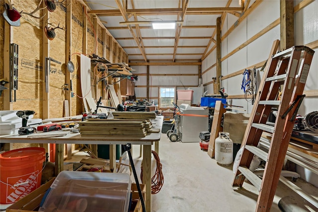 miscellaneous room with concrete flooring and a workshop area