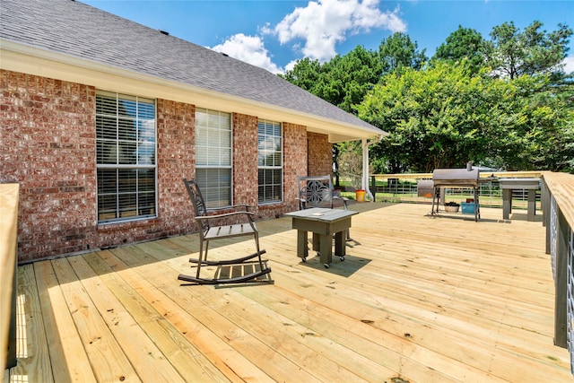 wooden deck featuring area for grilling