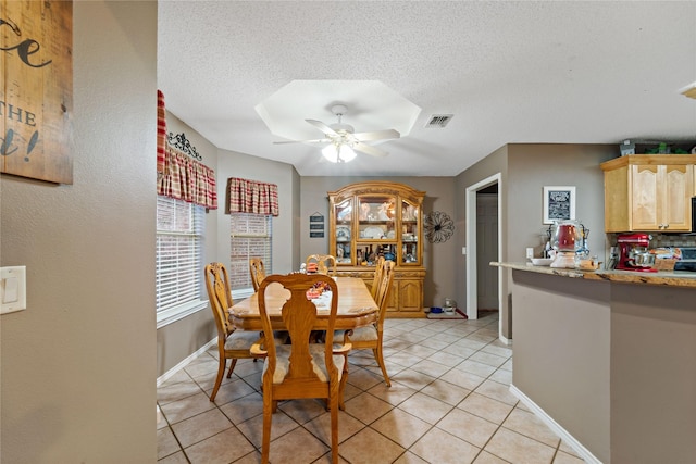 dining space with visible vents, baseboards, ceiling fan, a textured ceiling, and light tile patterned flooring