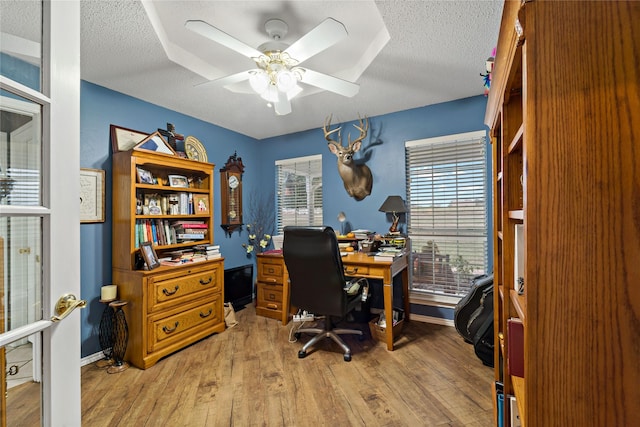 office featuring ceiling fan, a textured ceiling, and wood finished floors