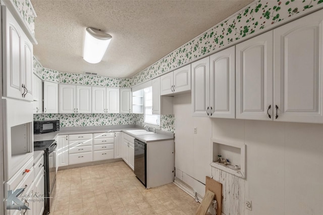 kitchen with white cabinetry, a sink, a textured ceiling, and black appliances